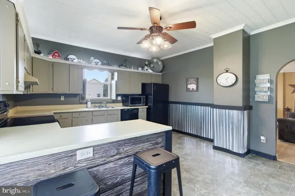 a large kitchen with a table and chairs