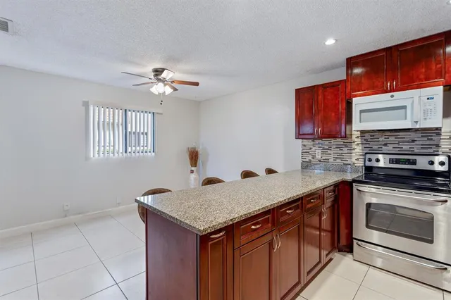 a kitchen with a sink stove and microwave