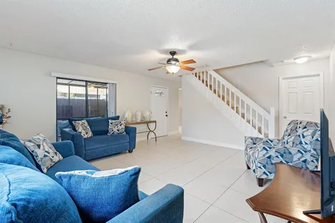 a living room with furniture and a chandelier