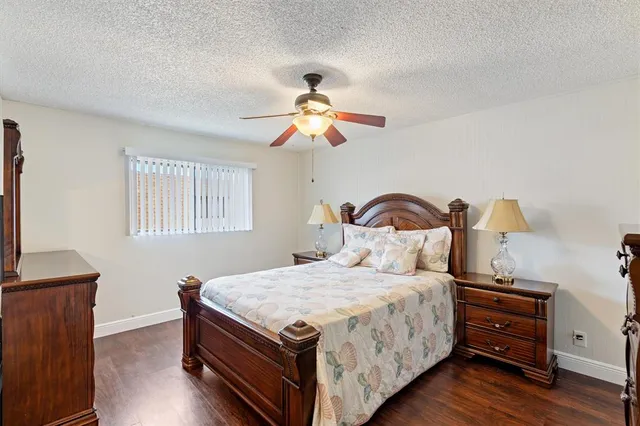 a bedroom with bed and a chandelier