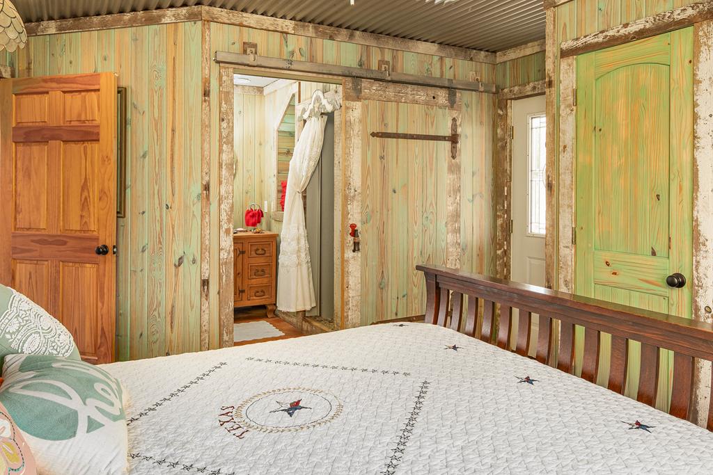 290 Japonica Road Hunt, TX 78024 - Photo 21 of 78 a bedroom with a bed and a chandelier