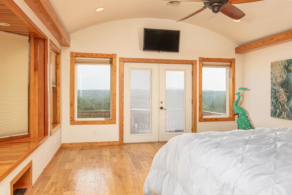 290 Japonica Road Hunt, TX 78024 - Photo 28 of 78 a bedroom with a large bed and a flat tv screen