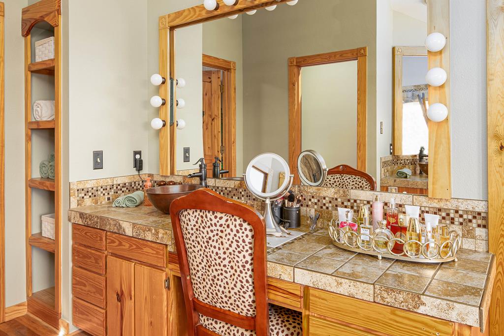 290 Japonica Road Hunt, TX 78024 - Photo 34 of 78 a large bathroom with a granite countertop sink and a mirror
