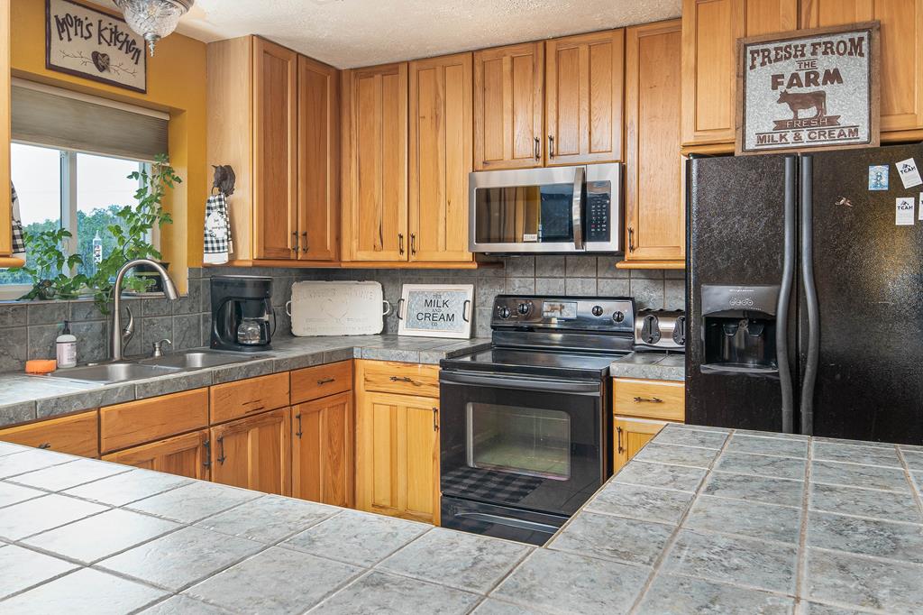 290 Japonica Road Hunt, TX 78024 - Photo 51 of 78 a kitchen with stainless steel appliances granite countertop a refrigerator sink and cabinets