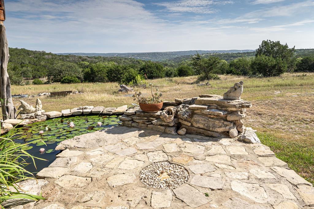 290 Japonica Road Hunt, TX 78024 - Photo 77 of 78 a view of a lake with a yard and mountain view