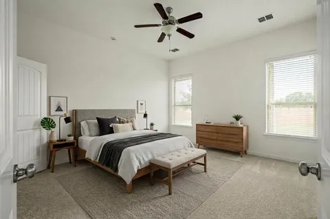 a bedroom with a bed dresser and a window