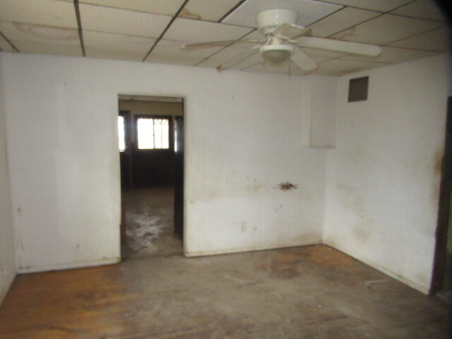 33 State Street Danville, IL 61832 - Photo 5 of 17 an empty room with a empty space and a ceiling fan