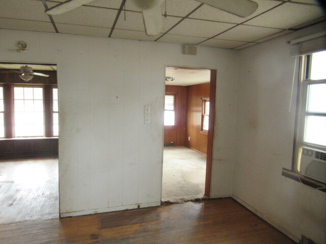 33 State Street Danville, IL 61832 - Photo 6 of 17 an empty room with wooden floor and windows
