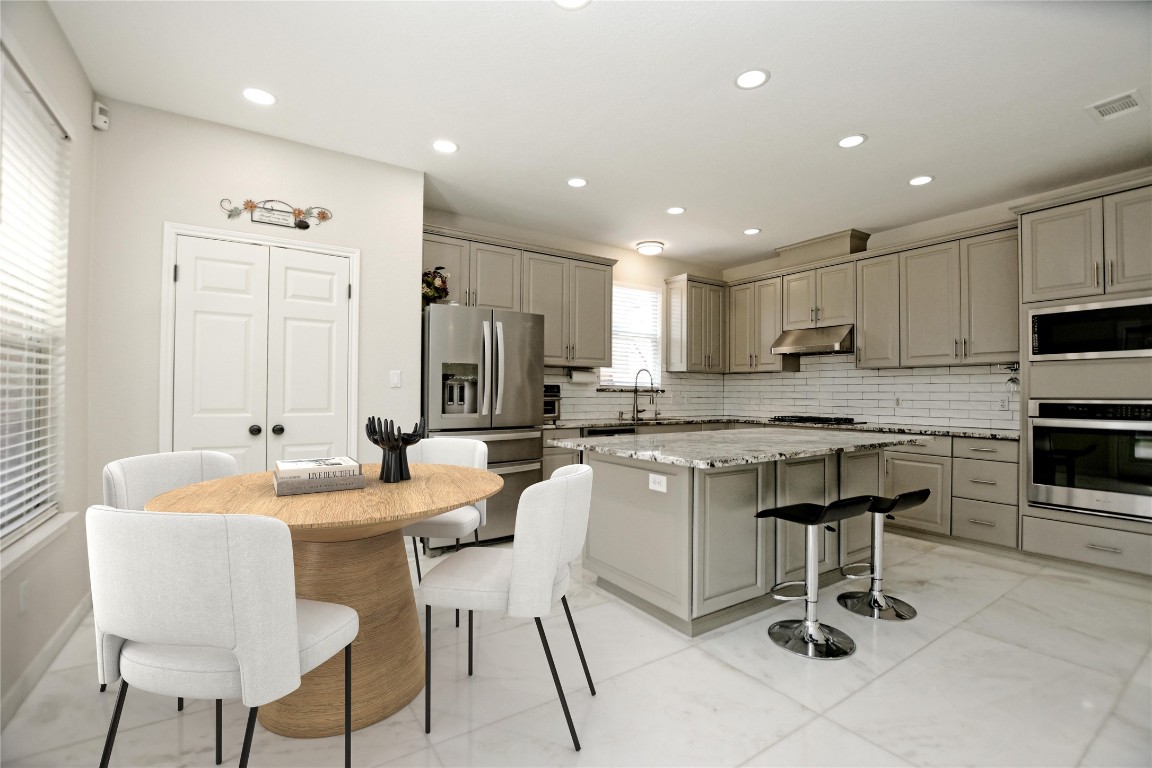 15701 Pumpkin Ridge Drive Austin, TX 78717 - Photo 14 of 37 appliances, gray cabinets, and under cabinet range hood