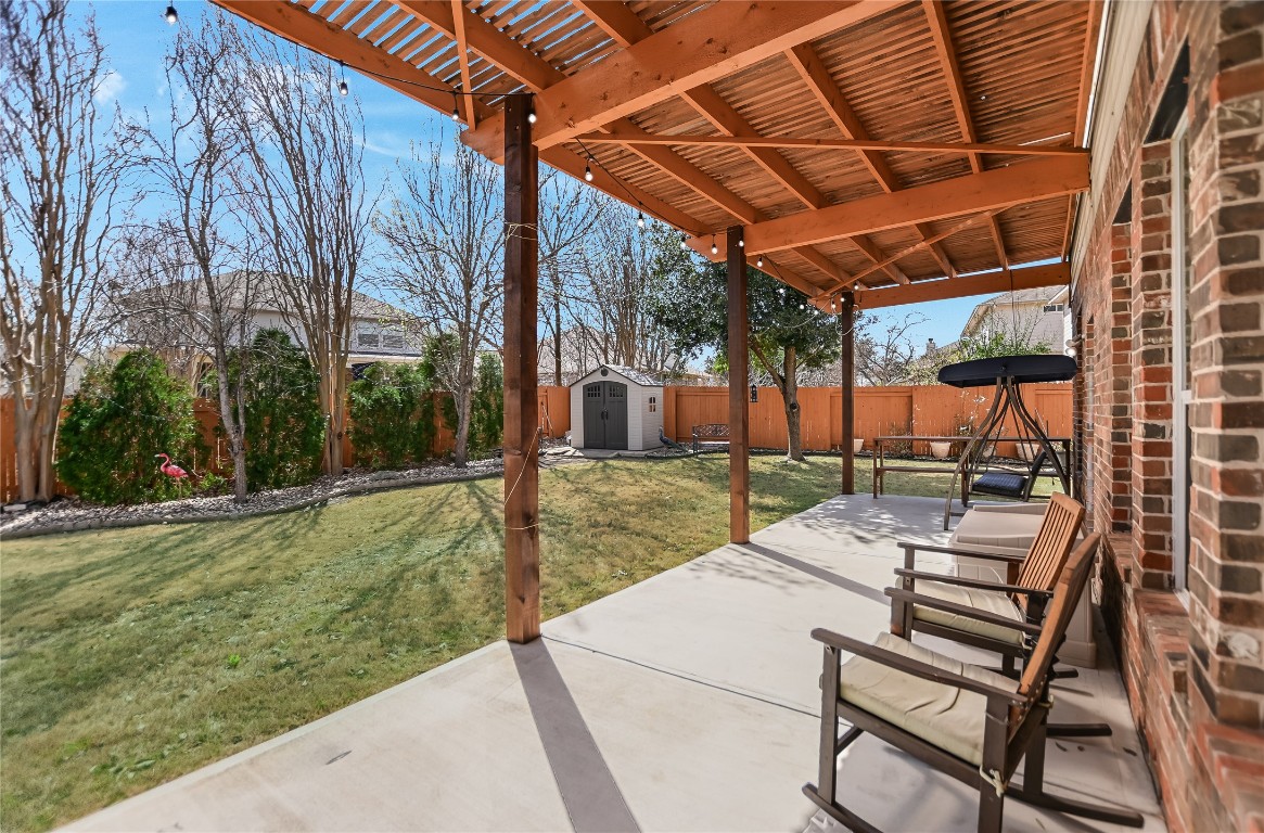 15701 Pumpkin Ridge Drive Austin, TX 78717 - Photo 30 of 37 View of patio / terrace with an outbuilding, a pergola, a fenced backyard, and a storage unit.