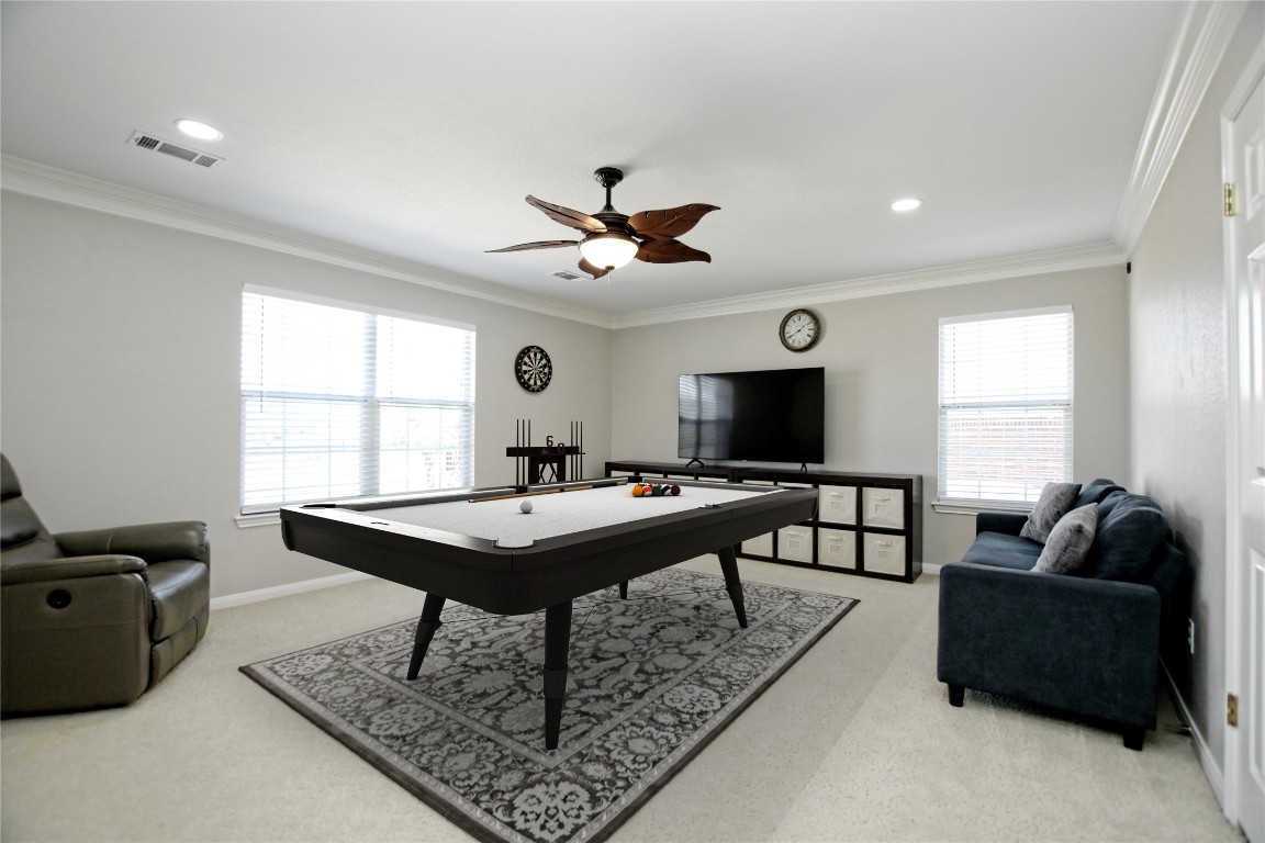 15701 Pumpkin Ridge Drive Austin, TX 78717 - Photo 8 of 37 Playroom featuring a healthy amount of sunlight, visible vents, and ornamental molding