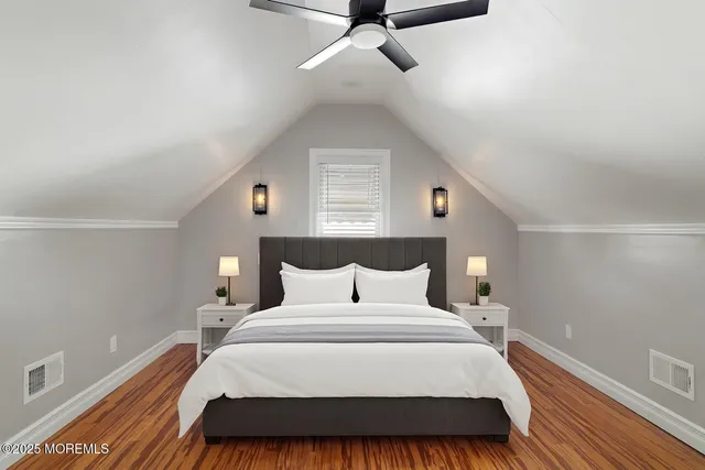 a bedroom with a bed and a night stand