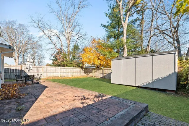a view of a backyard with large trees