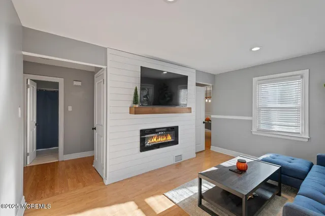 a living room with furniture fireplace and flat screen tv