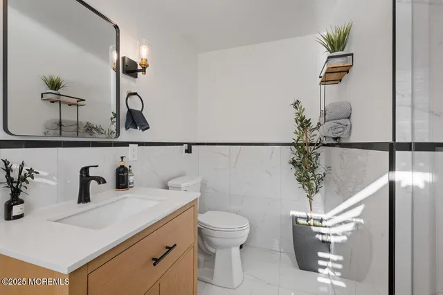 a bathroom with a sink a toilet and mirror