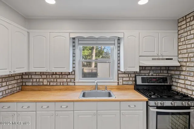 a kitchen with cabinets and window