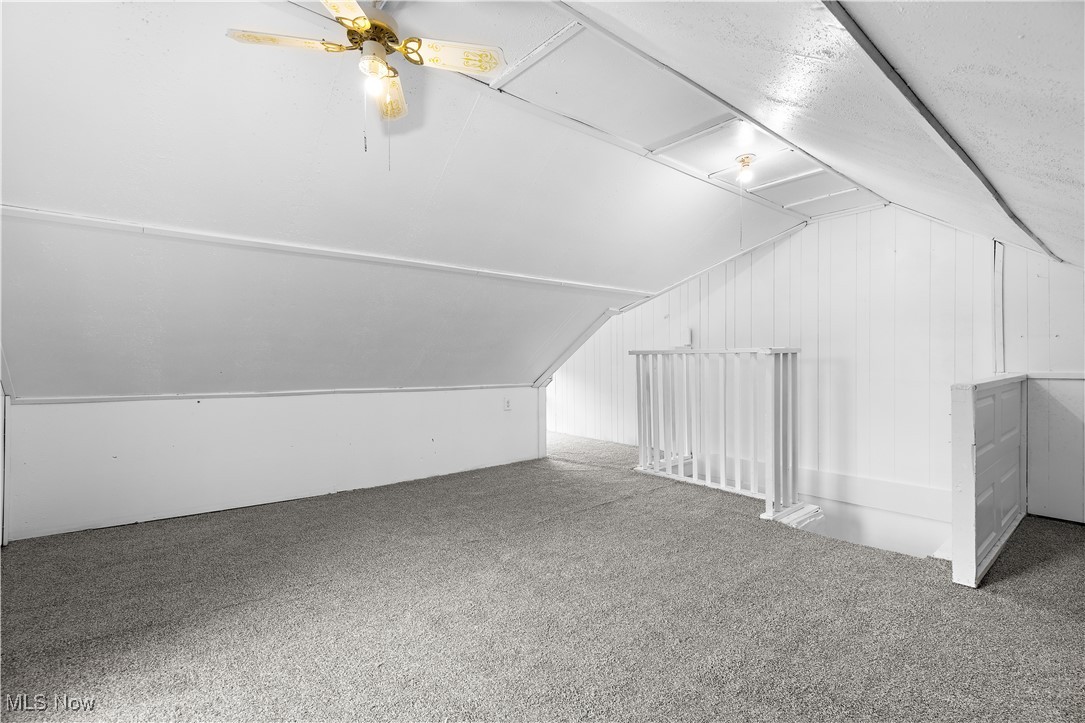 324 Root Road Lorain, OH 44052 - Photo 20 of 38 Bonus room with ceiling fan, wooden walls, lofted ceiling, and carpet