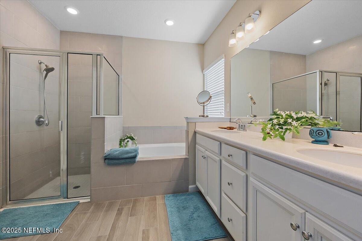102 Anguilla Boulevard St. Augustine, FL 32092 - Photo 11 of 25 a bathroom with a double vanity sink and shower