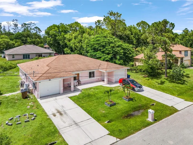 an aerial view of a house with pool yard and outdoor seating