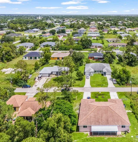 an aerial view of residential houses with outdoor space and street view