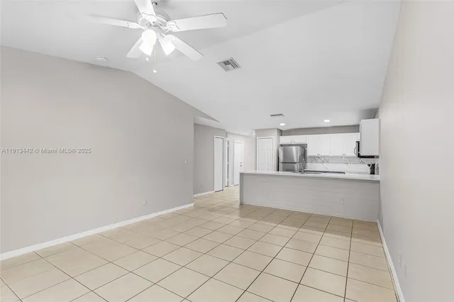 a view of kitchen with center island and stainless steel appliances