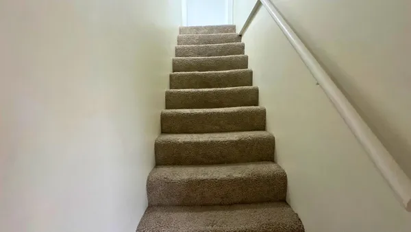 a view of staircase with white walls