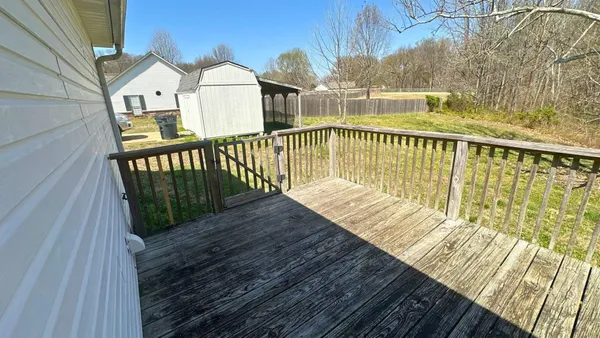 a view of a balcony with wooden floor