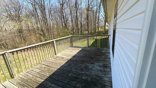 a view of balcony with wooden floor