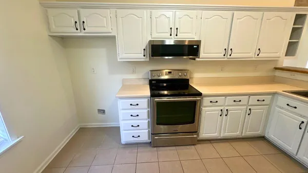 a kitchen with stainless steel appliances a stove a microwave and cabinets