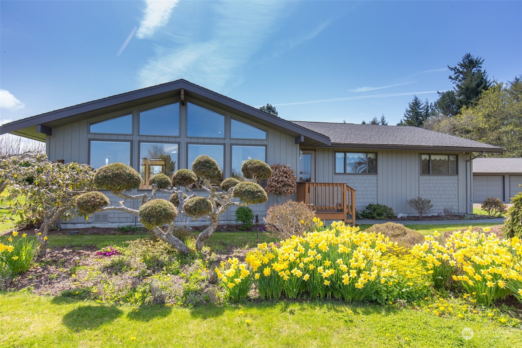 83 Mariners Point Road Sequim, WA 98382 - Photo 1 of 40 a front view of a house with garden