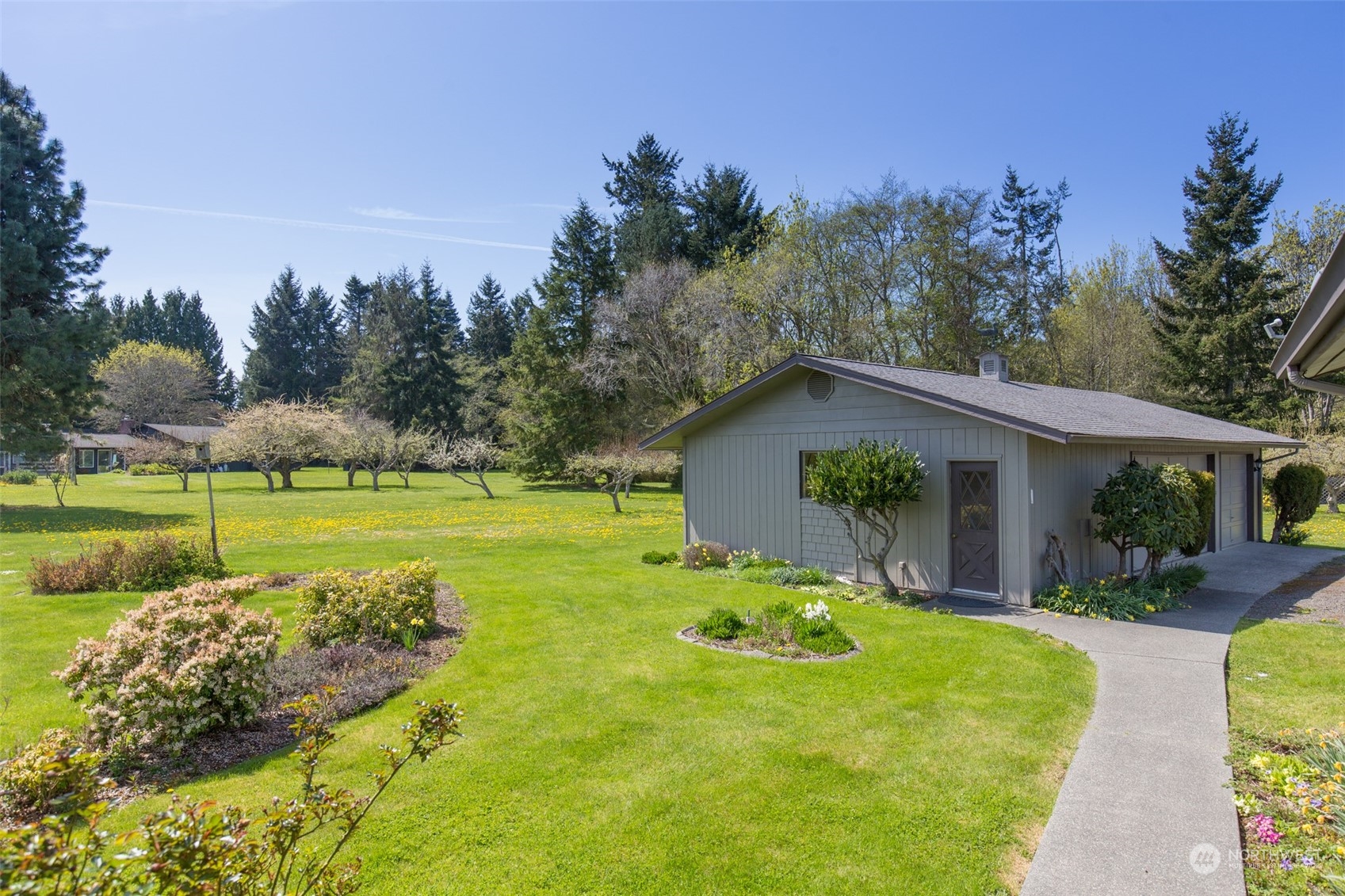 83 Mariners Point Road Sequim, WA 98382 - Photo 3 of 40 a view of a house with pool and a garden