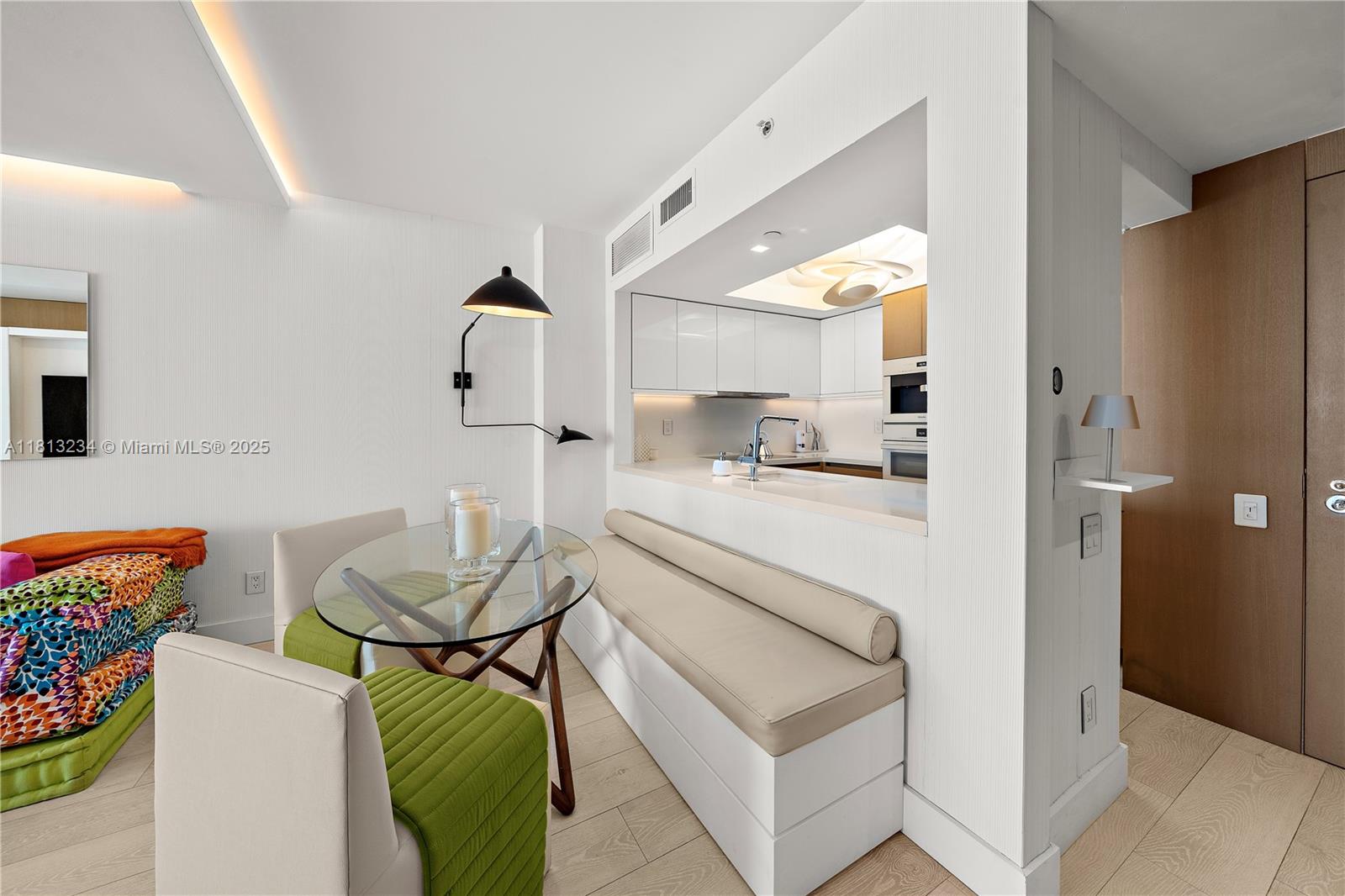 1500 Ocean Drive, Unit 910 Miami Beach, FL 33139 - Photo 17 of 40 a living room with furniture and a dining table