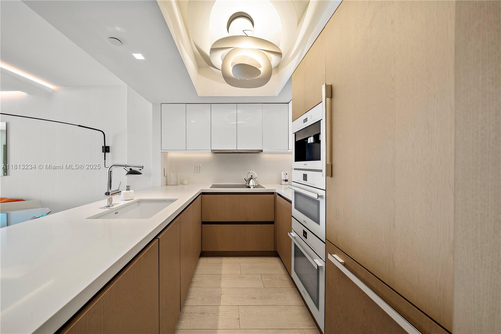 1500 Ocean Drive, Unit 910 Miami Beach, FL 33139 - Photo 18 of 40 a kitchen with a sink a stove and cabinets