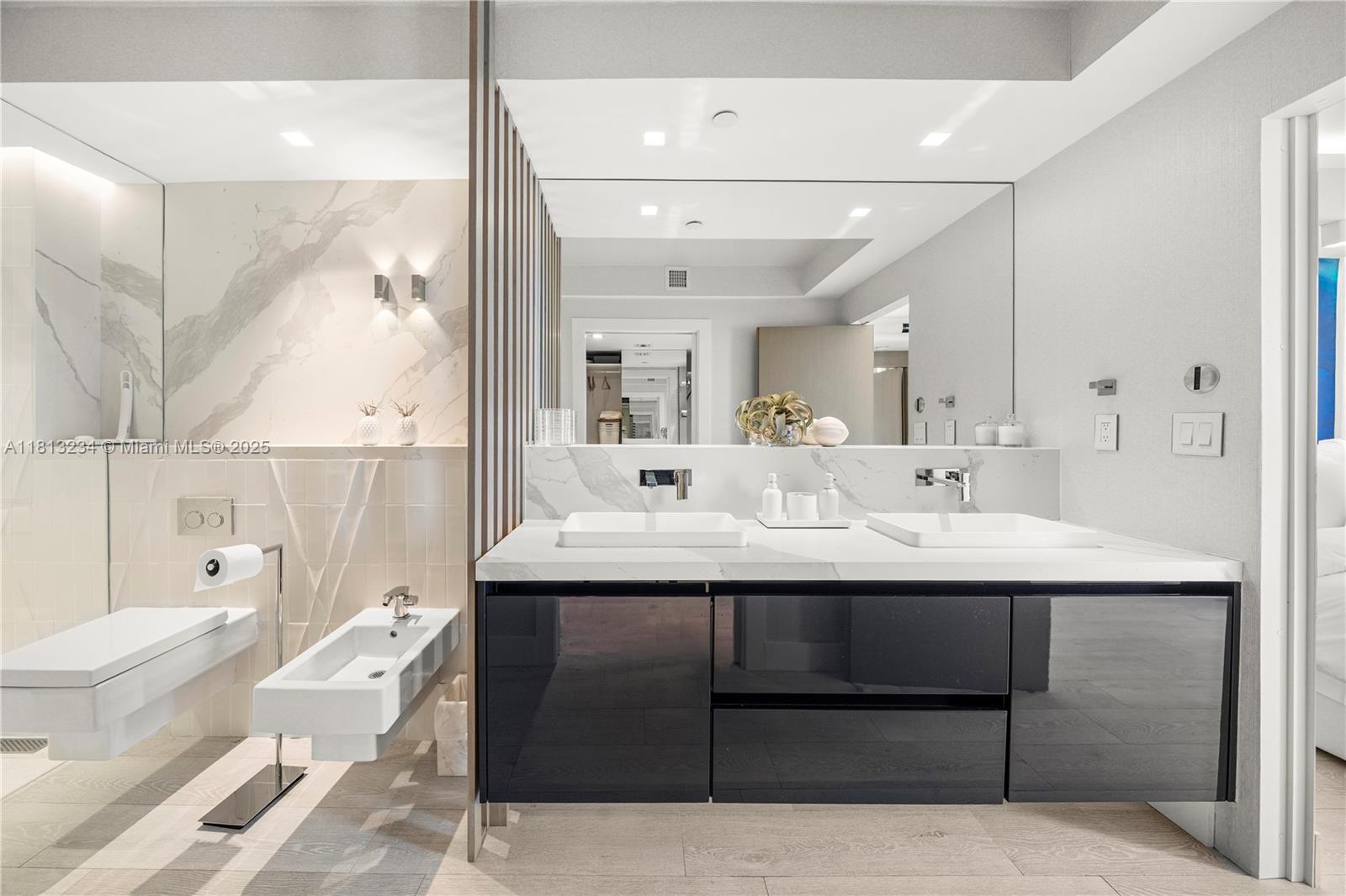 1500 Ocean Drive, Unit 910 Miami Beach, FL 33139 - Photo 36 of 40 a en suite bathroom with a double vanity sink a mirror and a bathtub