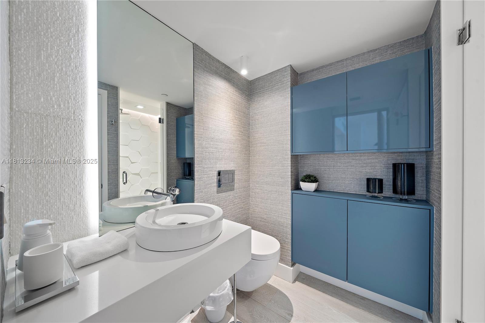 1500 Ocean Drive, Unit 910 Miami Beach, FL 33139 - Photo 9 of 40 a bathroom with a sink a toilet and a mirror