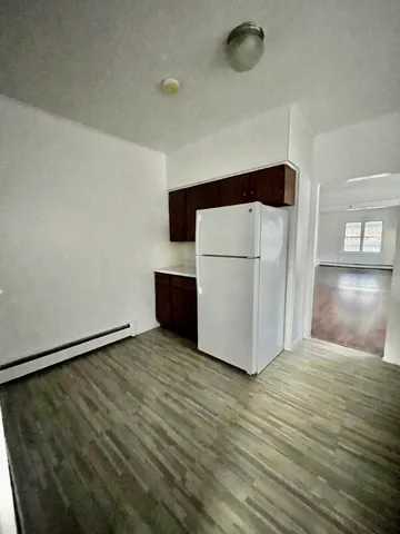 a view of kitchen with refrigerator and microwave