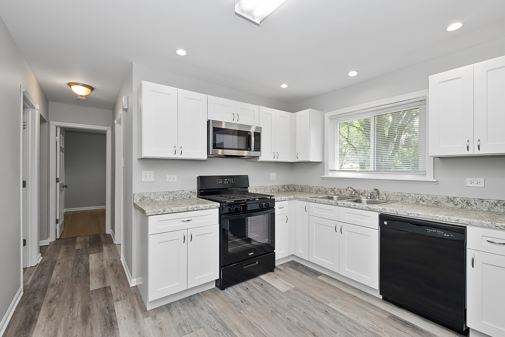 11700 South Harding Avenue Alsip, IL 60803 - Photo 15 of 17 a kitchen with a sink stove a microwave and cabinets