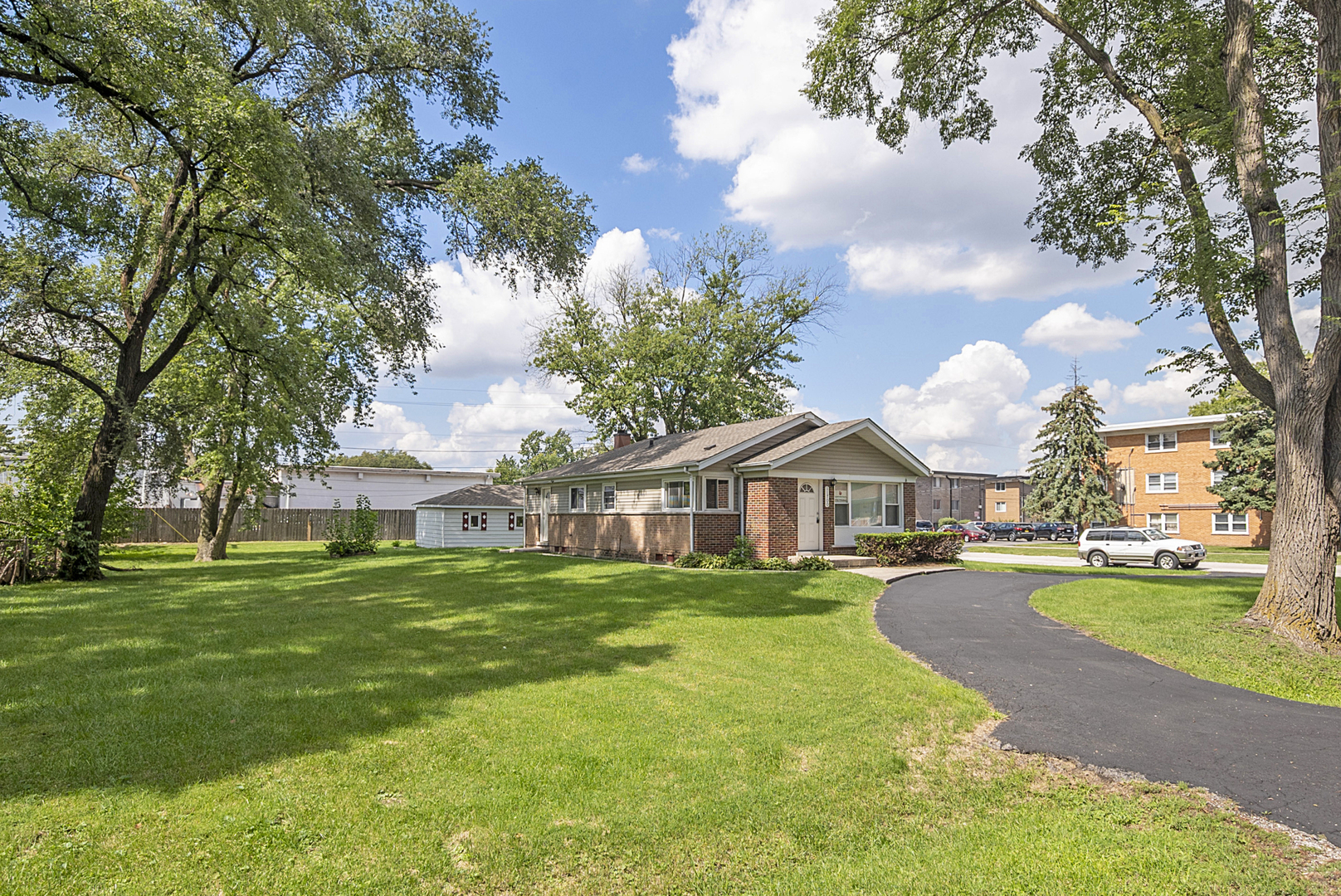 11700 South Harding Avenue Alsip, IL 60803 - Photo 2 of 17 a front view of a house with a yard and trees