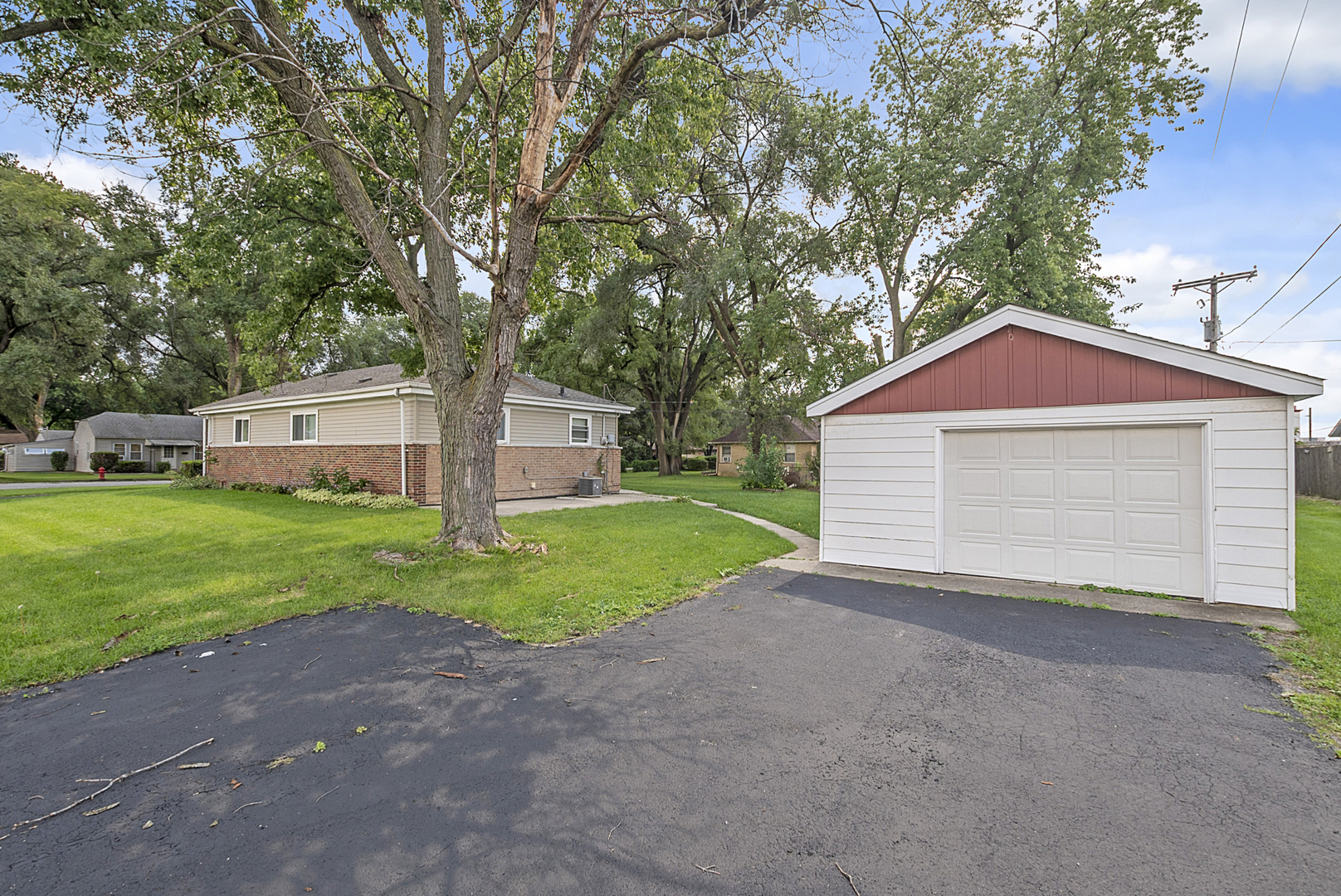 11700 South Harding Avenue Alsip, IL 60803 - Photo 6 of 17 a view of a house with a small yard and large tree