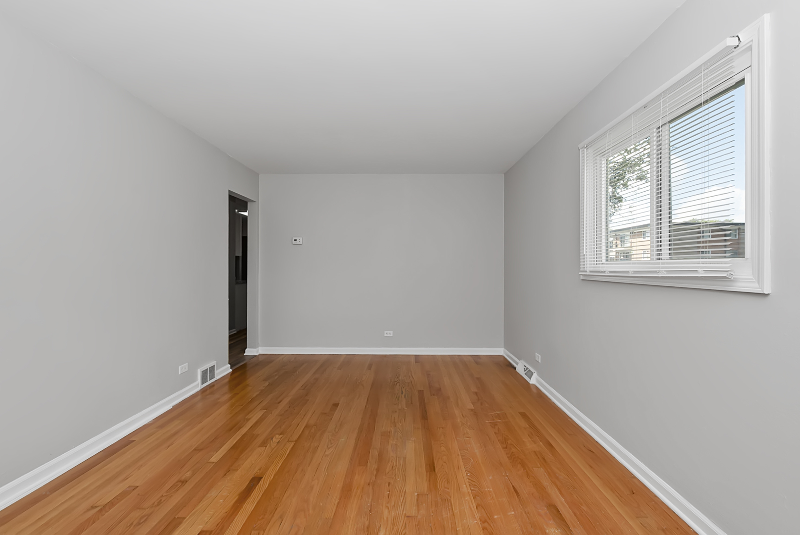 11700 South Harding Avenue Alsip, IL 60803 - Photo 7 of 17 an empty room with wooden floor and windows