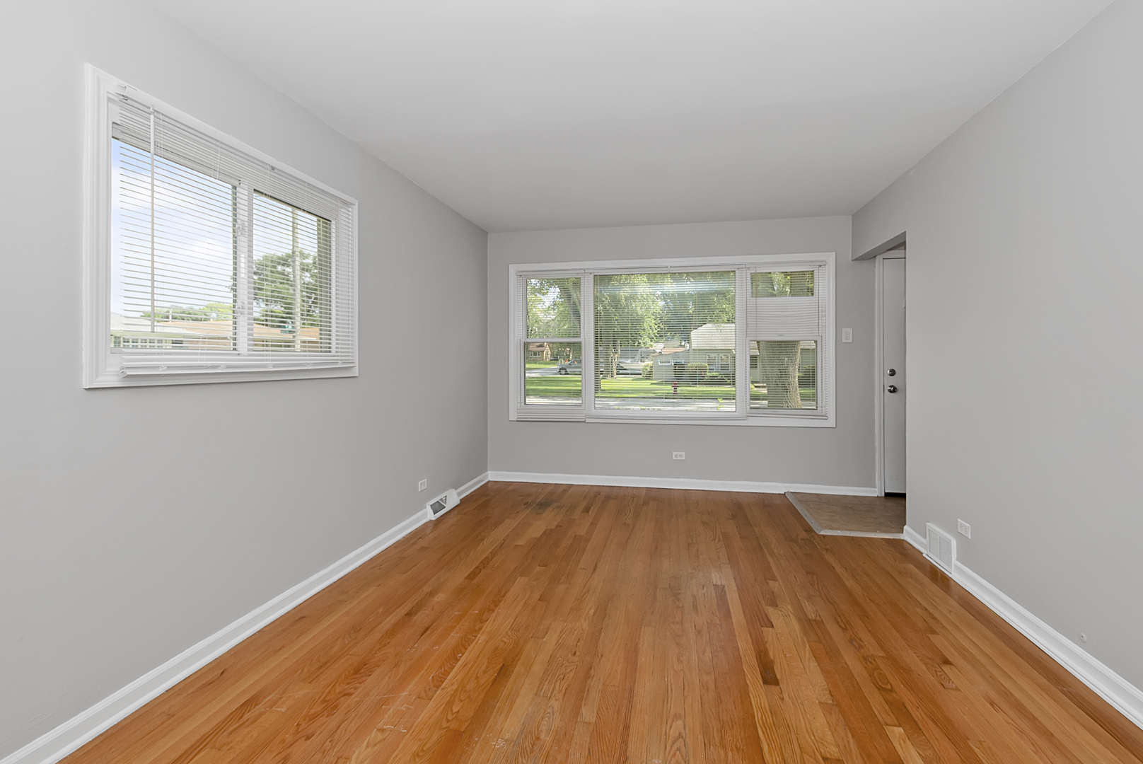 11700 South Harding Avenue Alsip, IL 60803 - Photo 9 of 17 an empty room with wooden floor and windows