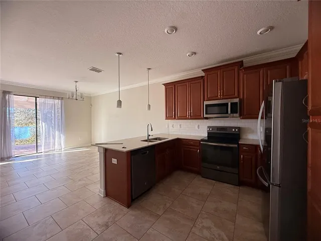 a view of a livingroom with a furniture a chandelier fan and windows