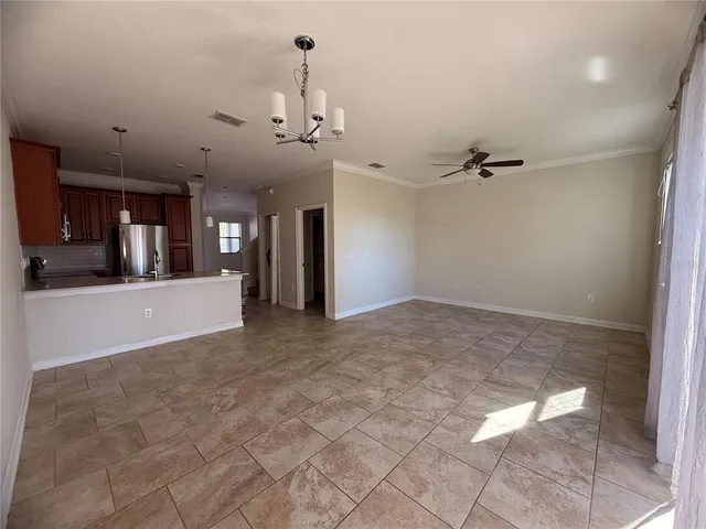 a kitchen with stainless steel appliances granite countertop a refrigerator a sink and a stove