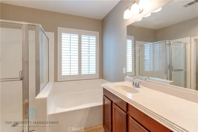a bathroom with a tub sink and mirror