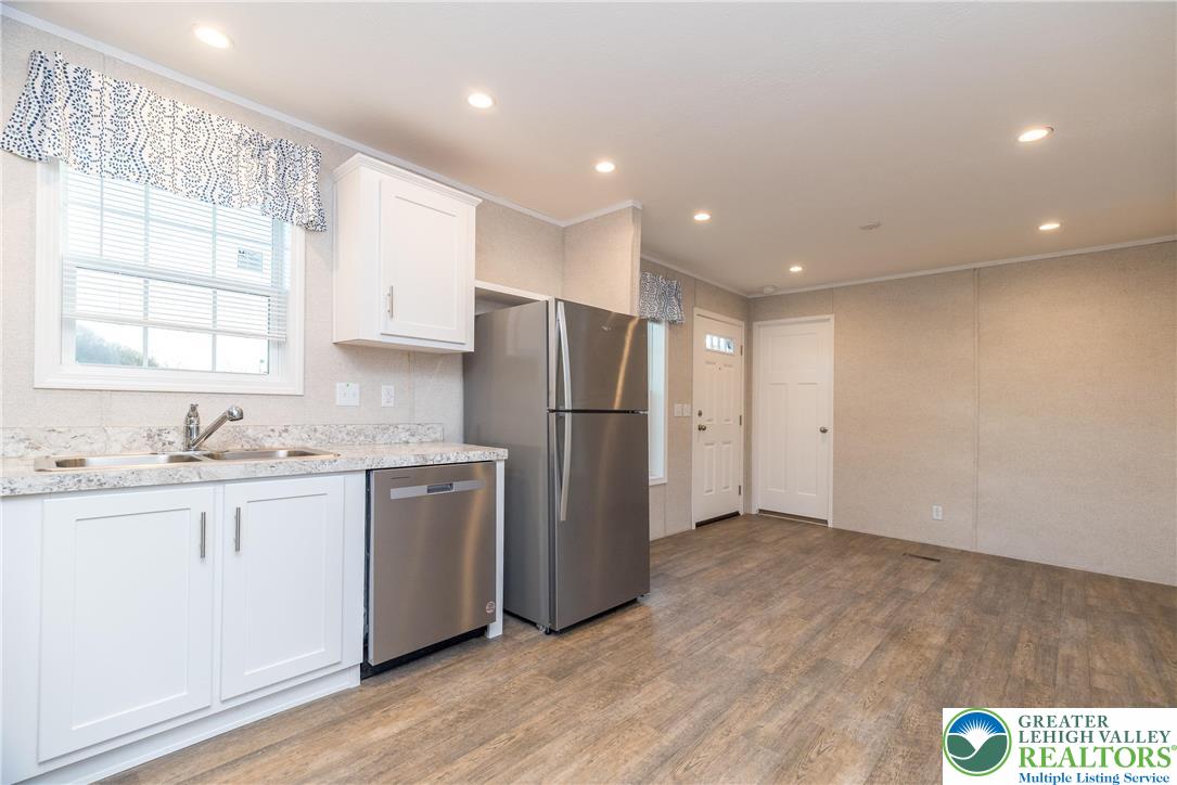 465 Royal Manor Road, Unit LOT 3 Easton, PA 18042 - Photo 3 of 13 a kitchen with stainless steel appliances granite countertop a refrigerator and a sink