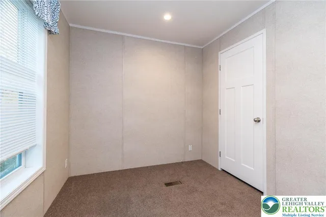 a room with a refrigerator and wooden floor