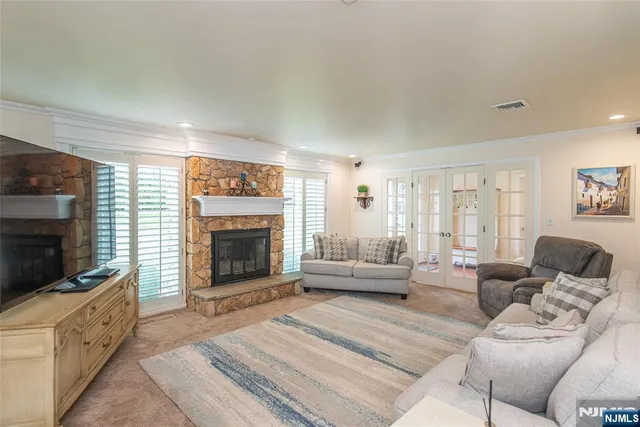 a living room with furniture a fireplace and a flat screen tv