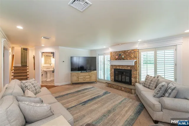 a living room with furniture a fireplace and a flat screen tv