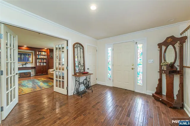 a view of a livingroom with wooden floor and furniture