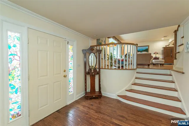 a view of entryway with wooden floor and door
